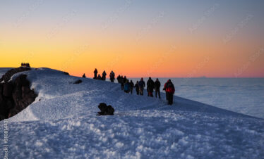 hikers on the ridge ascend mount kilimanjaro the tallest peak in africa.