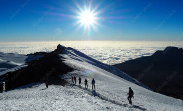 hikers on the ridge ascend mount kilimanjaro the tallest peak in africa.