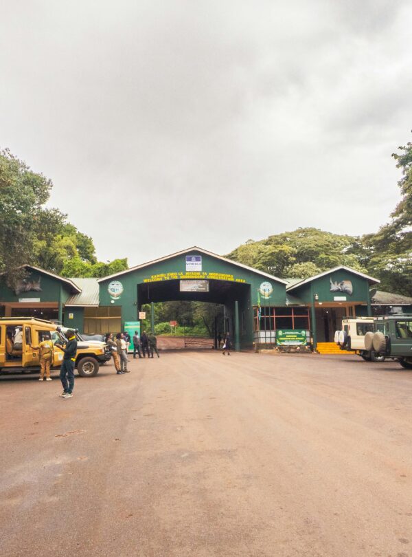 Safari vehicles at the entrance of Arusha National Park in Tanzania.